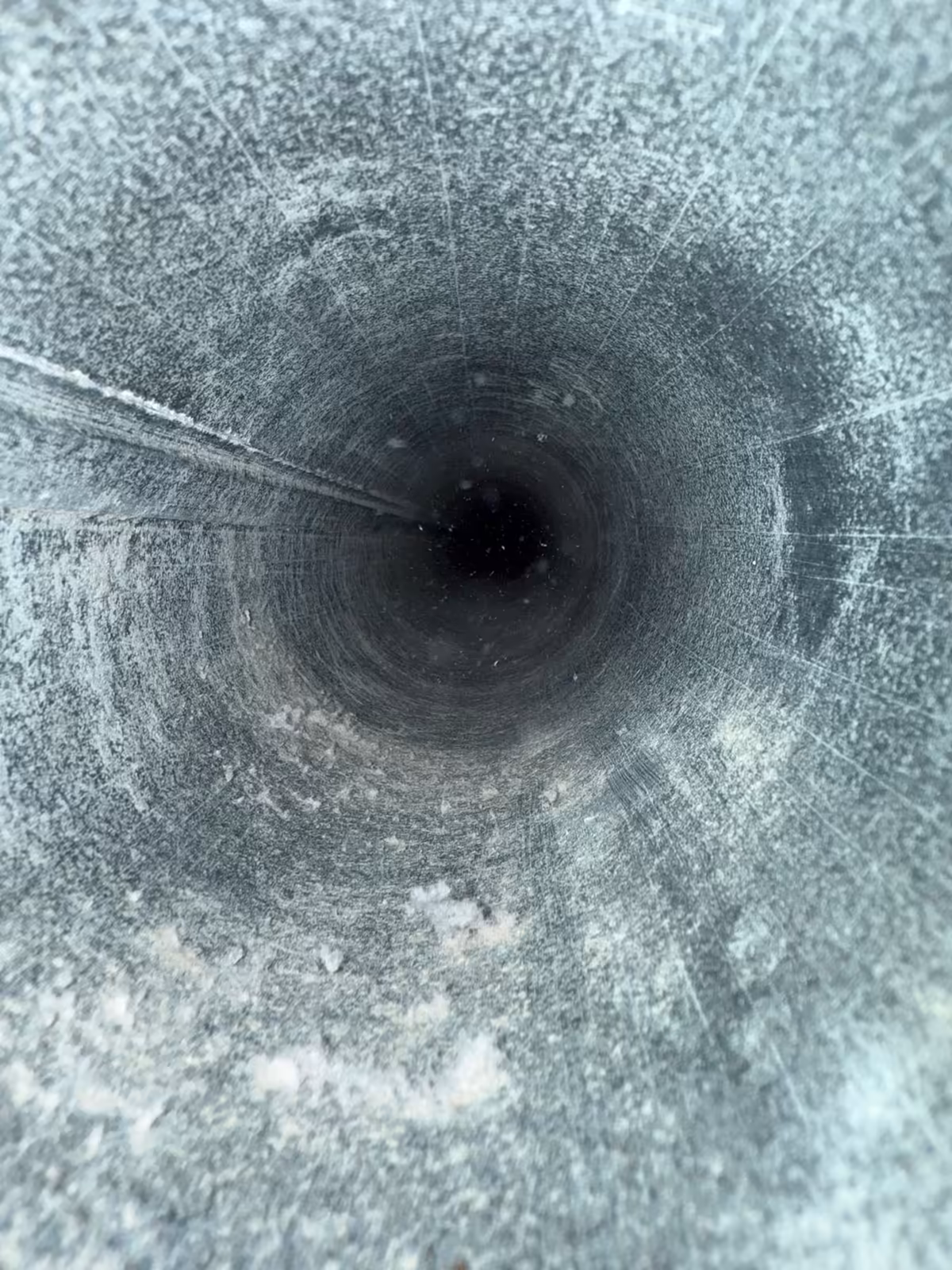 The same dryer vent pipe after cleaning, the coating brushed off and the bore clear end to end