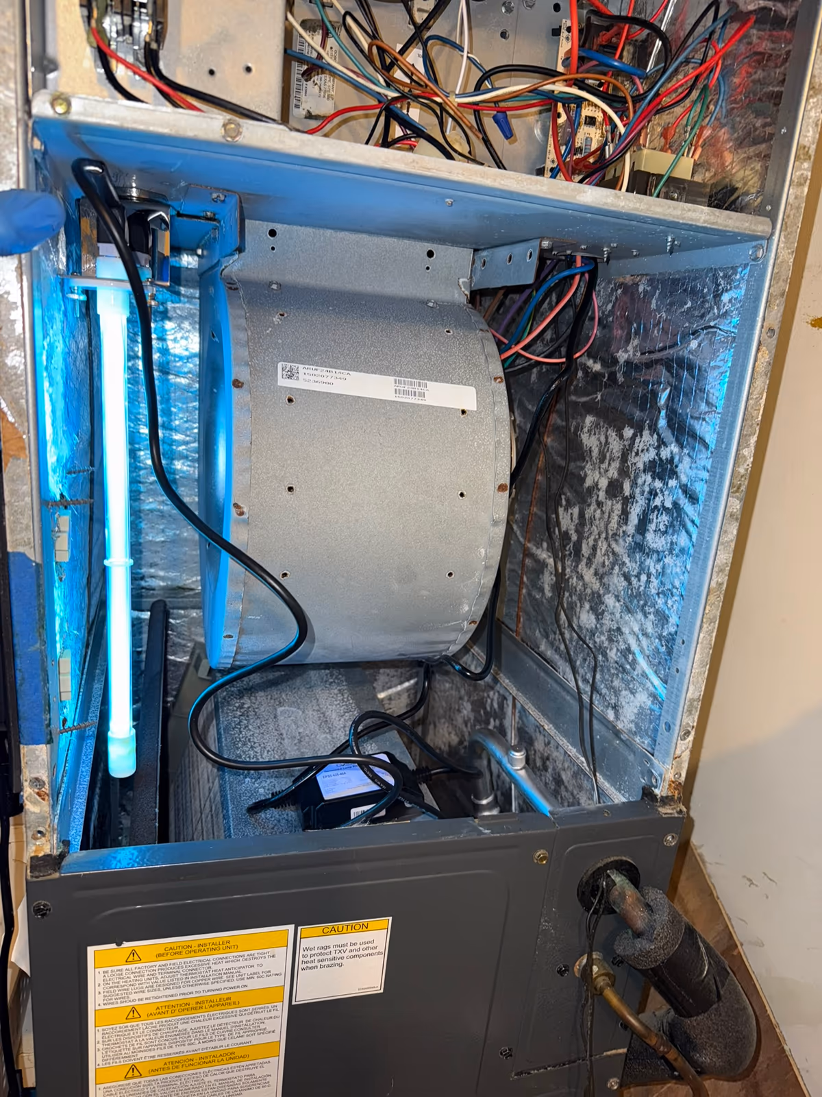 UV-C lamp glowing inside an open air handler cabinet after installation